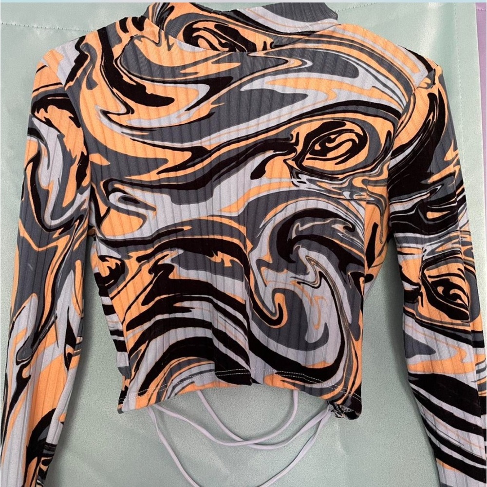 Black and orange swirl print crop top.